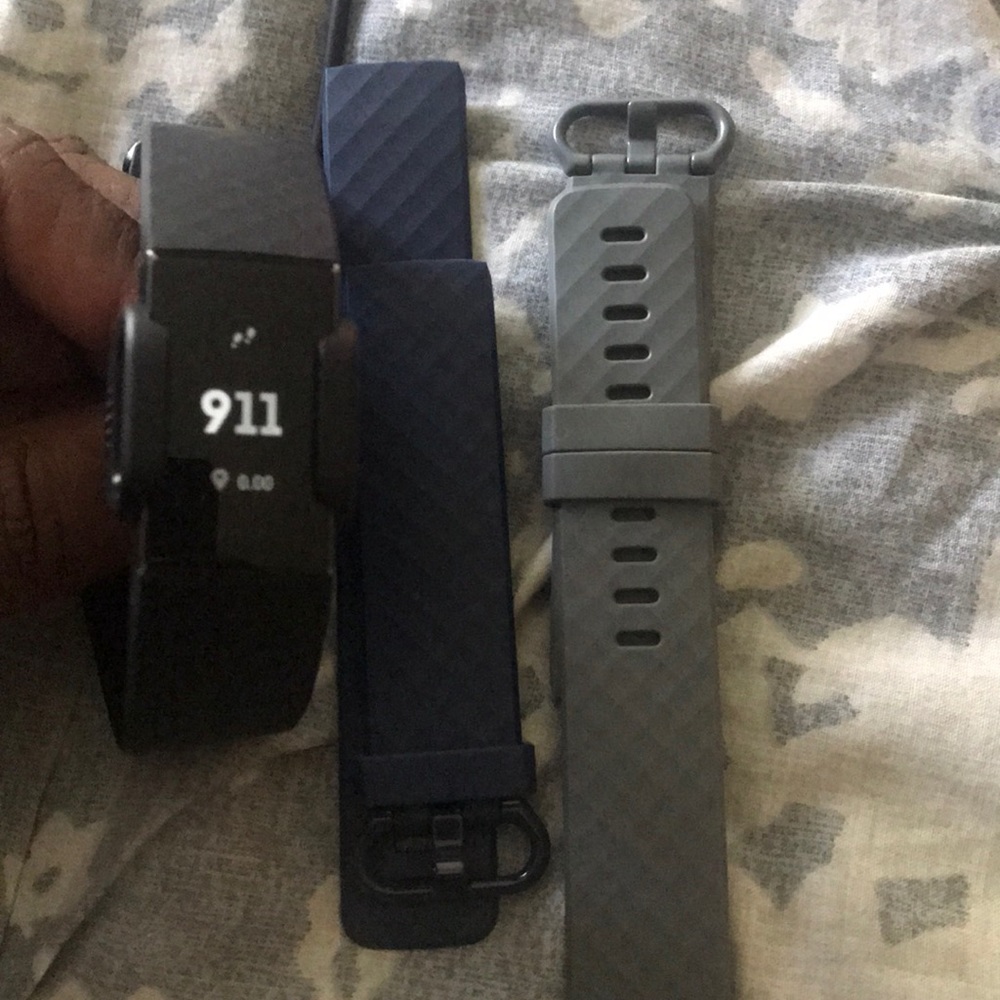 Fitbit watch with two extra bands.
